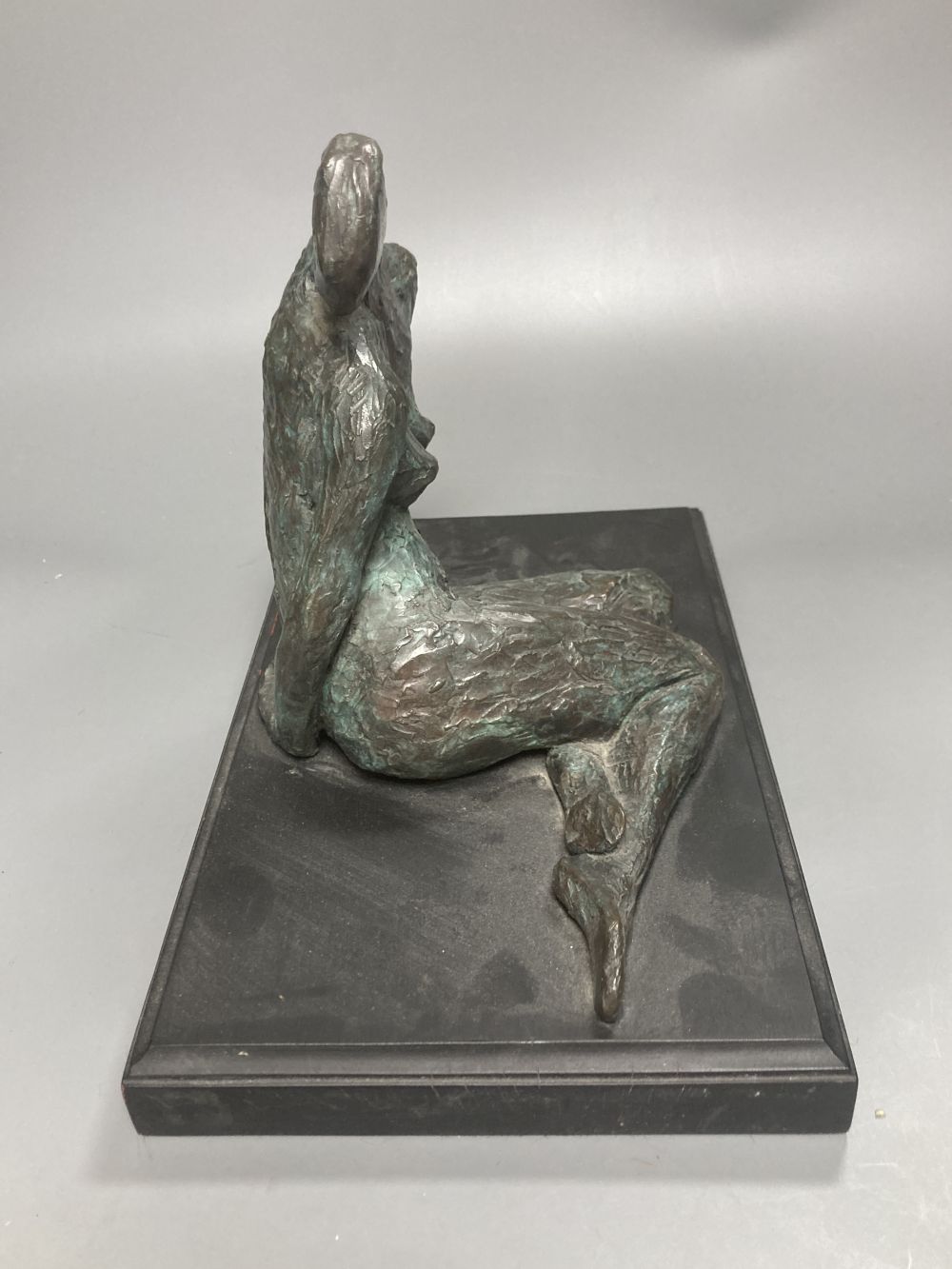 A contemporary bronze figure of a seated female figure, ebonised plinth 29.5cm wide